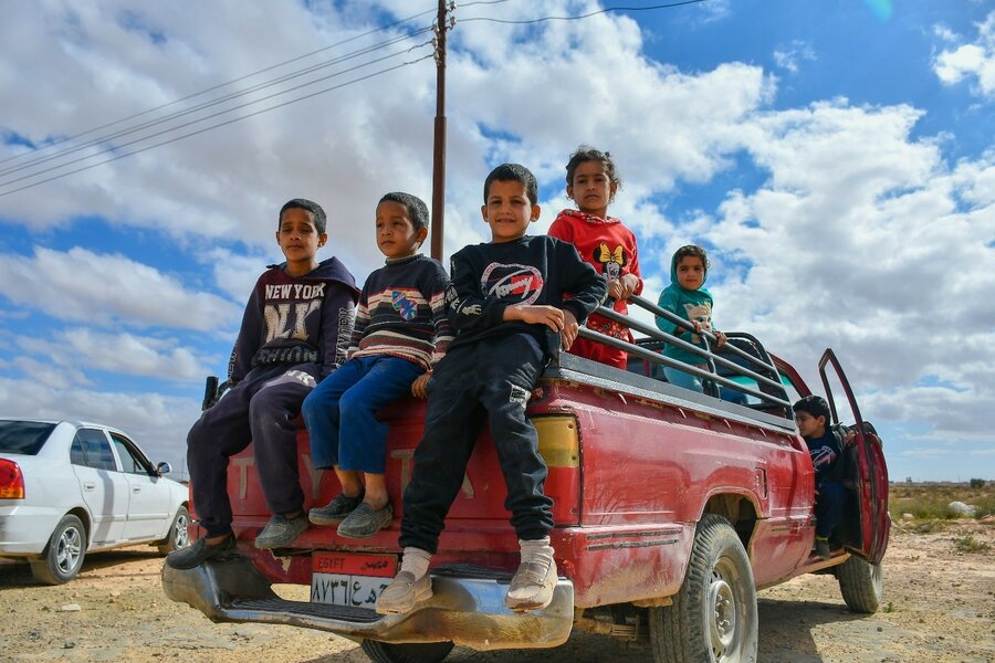 Five of Mahmoud's children sit in the back of a pickup truck on their way to the town centre.